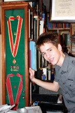 Ciaran Brown by the case that holds Patrick's honours - his knighthood (above) and his CBE (below)